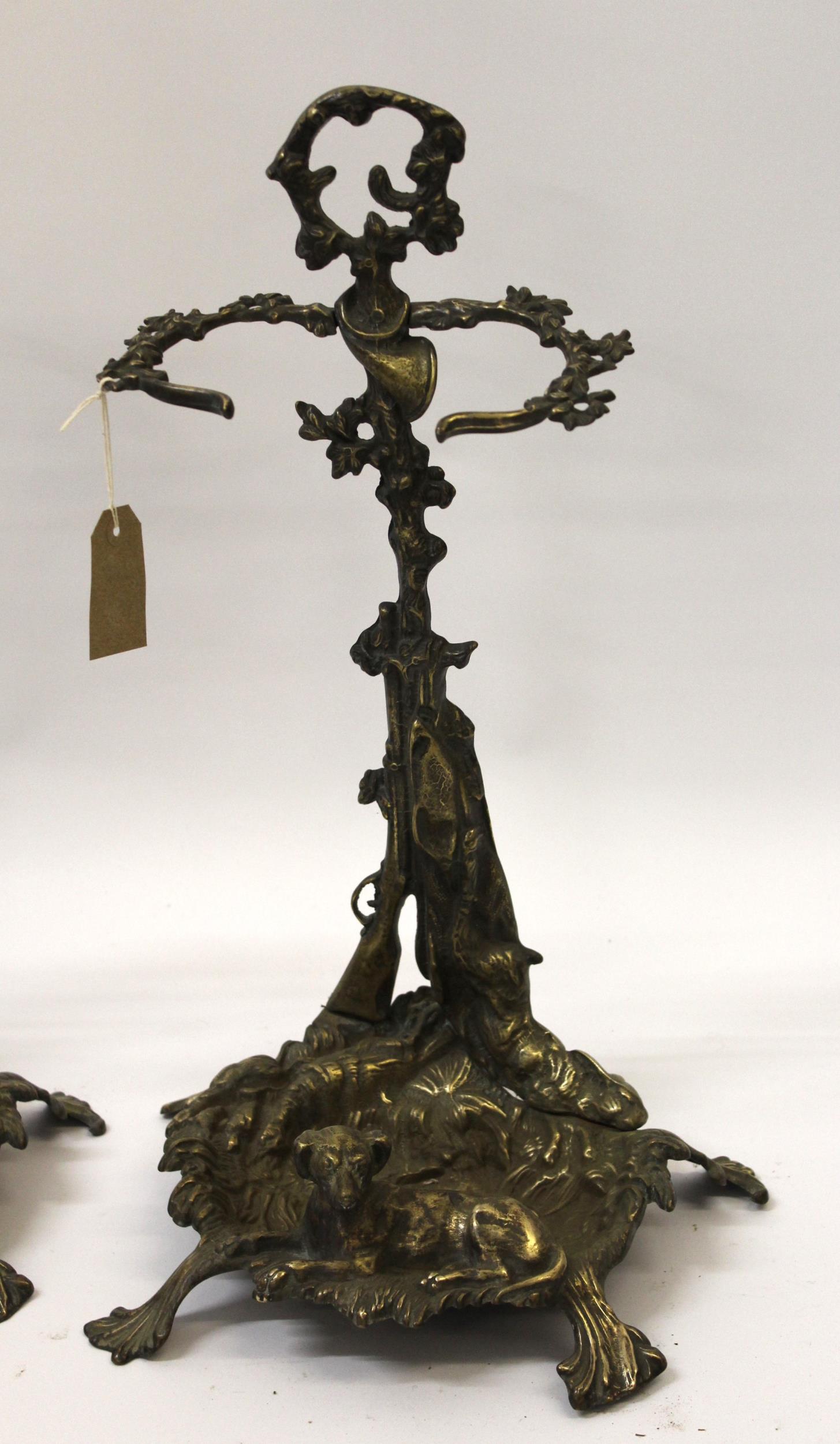 Pair of ornate brass stick stands mounted with figures of dogs, 56cm high - Image 2 of 3