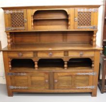 Arts & Crafts oak sideboard, the canopy top above an arrangement of drawers, alcoves and