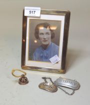 Small silver photograph frame, 15 x 11cm overall, together with one silver decanter label, another