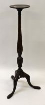 Edwardian mahogany torchere with a circular dish top above a fluted baluster column on tripod base