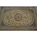 Indo Persian carpet with a medallion and all-over stylised floral design on an ivory ground with