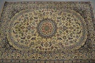 Indo Persian carpet with a medallion and all-over stylised floral design on an ivory ground with