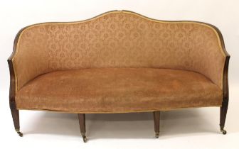 George III mahogany humpback sofa with moulded frame on square reeded supports with later casters,