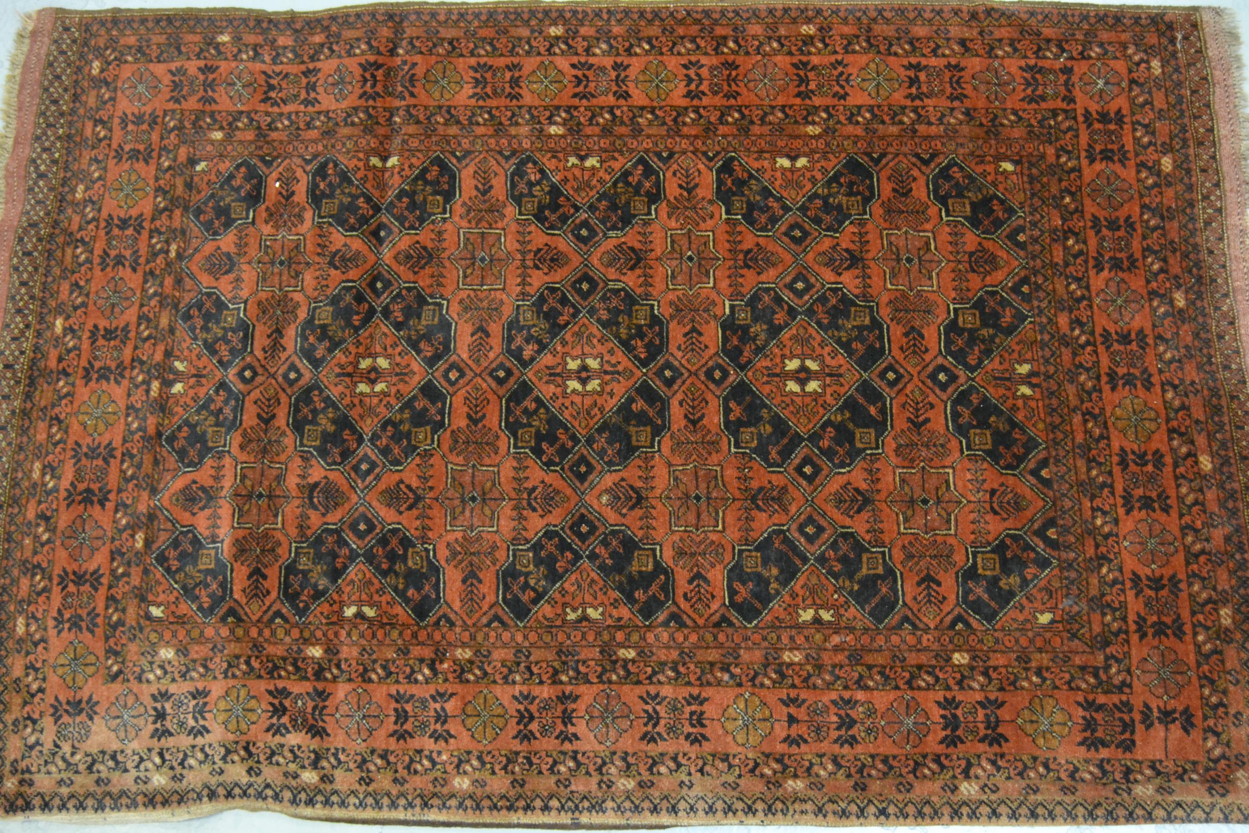 Belouch rug with all over design in shades of madder and black with borders, 185 x 127cm