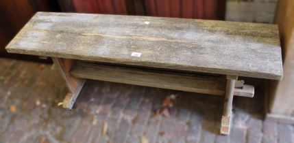 Pine garden bench on slab end supports