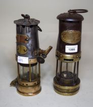 Two antique metal and brass miners lamps by J.H. Naylor Limited and E. Thomas & Williams Limited