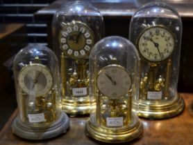 Group of four mid 20th Century anniversary clocks under perspex domes