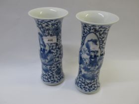 Pair of Chinese cylindrical vases, blue and white decorated, with panels of figures, signed with