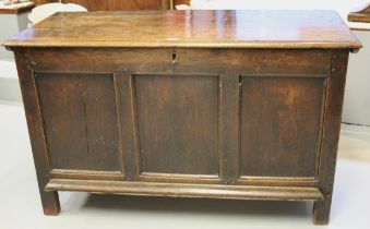 17th Century oak coffer, the hinged lid above a three panel front on stile supports, 127cm wide