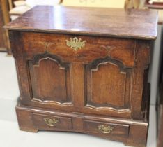 Late 18th / early 19th Century oak coffer, the plank top above a two panelled shaped front with