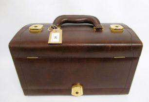 Brown leather vanity case with mirror and fittings to the interior, having jewellery compartment