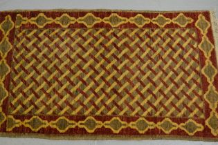 Small Indo Persian matt with a lattice design on a beige ground, 100 x 60cm, together with a Belouch