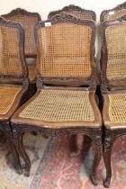 Set of eight 19th Century French salon chairs, the carved cresting rails above cane backs and