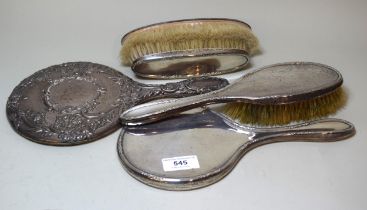 Chester silver hand mirror with embossed floral decoration, together with a three piece silver