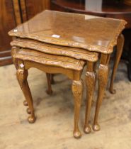 Nest of three mid 20th Century burr walnut rectangular occasional tables with carved rims and