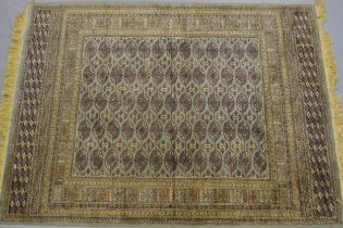 Machine woven rug of Turkoman design with five rows of gols on a green ground with borders, 168 x