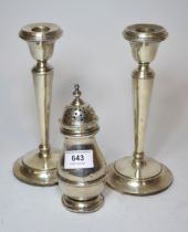 Pair of Birmingham silver candlesticks of tapering form, together with a London silver sugar caster