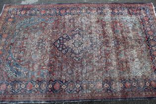 Tabriz rug with a lobed medallion and all-over floral design on a red ground with borders (very