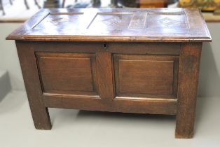 17th Century oak coffer, the hinged three panel lid above a two panel front on stile supports,