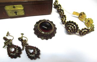 Suite of 19th Century gilt metal and garnet set jewellery comprising a necklace, brooch, bracelet