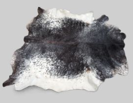 Mottled black, brown and white full cowhide rug Some rough areas and a few cuts as shown in