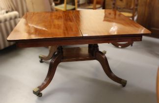 Unusual late Regency mahogany rectangular extending dining table, the tilt top above a large
