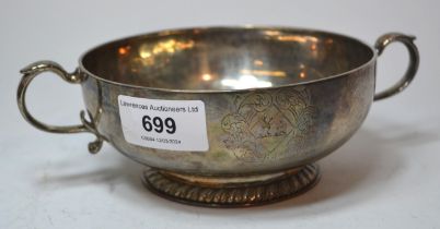 18th Century silver two handled bowl of shallow squat design, engraved with a family crest, the