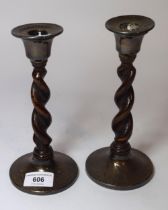 Pair of 20th Century silver mounted and oak barley twist candlesticks (some dents to silver mounts)