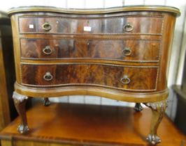 Early 20th Century mahogany kidney shaped chest, the galleried top above three drawers with brass