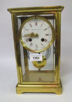 Early 20th Century gilt brass four glass library clock, the enamel dial with red Roman and black