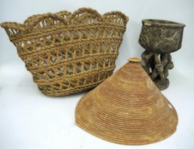 African tribal carved hardwood cup on stand, 31cm high, together with a raffia work hat and basket