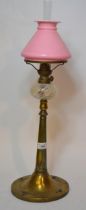 Art nouveau brass oil lamp with a pink shade and opalescent glass well, the base with applied enamel