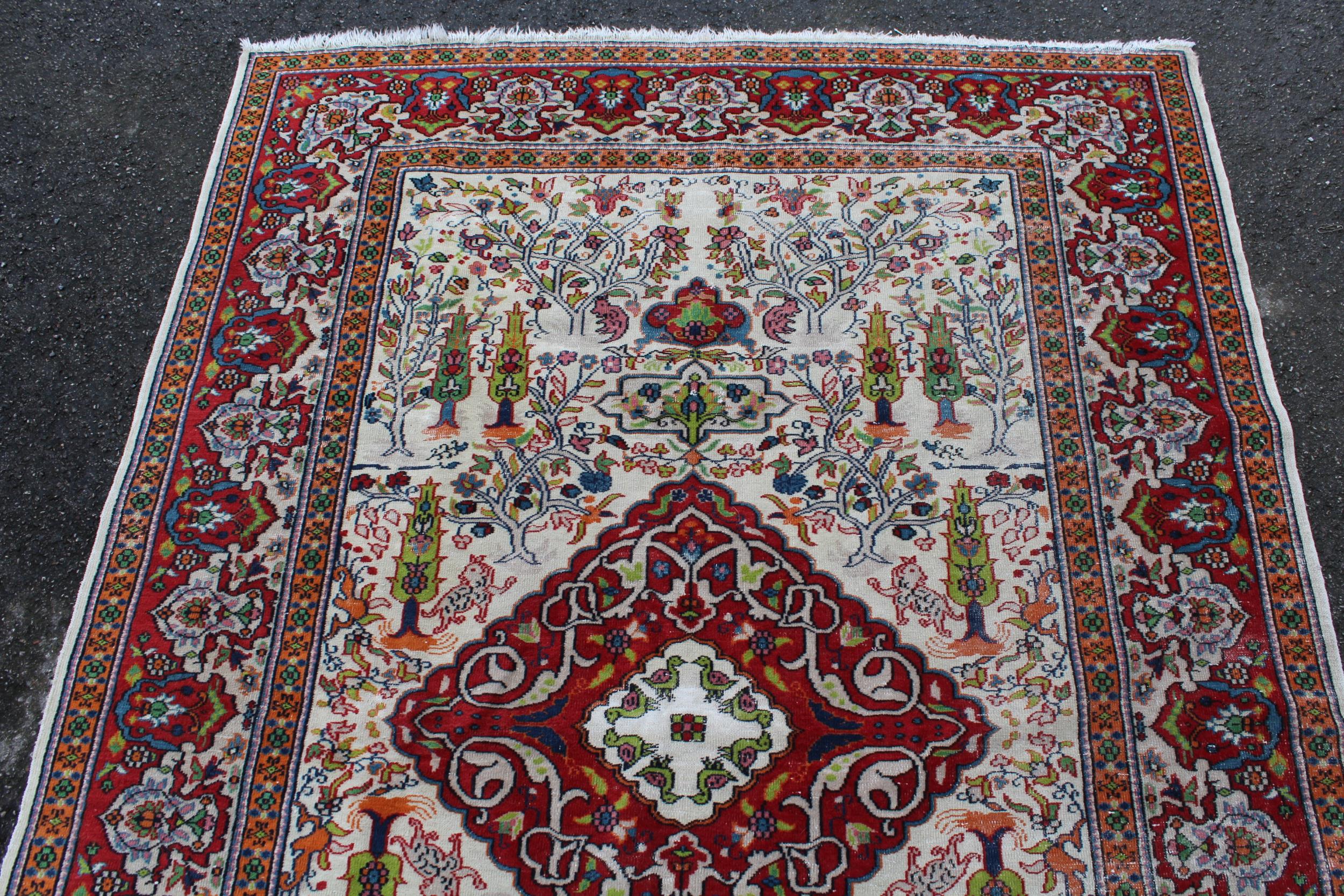 Small Indian rug with a medallion and all-over animal and garden design on an ivory ground with - Image 3 of 4