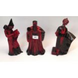 Group of three Royal Doulton flambe figures, The Wizard ' Confucius ' and The Carpet Seller (head at