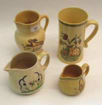 Ashtead Potters group of three decorative jugs and a tall tankard decorated with rabbits (cracked to