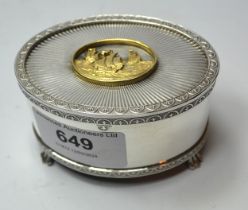 Oval silver musical trinket box, the cover having gilt mounted plaque decorated with masted galleons