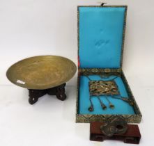 Chinese white metal pendant in a silk covered box, together with a small Chinese brass dish on a