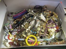 Shoe box containing a quantity of various costume jewellery, necklaces etc.