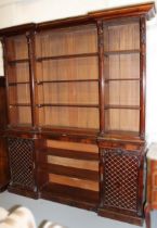 19th Century mahogany inverted breakfront bookcase, the moulded cornice above three adjustable
