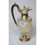 Birmingham silver claret jug in Georgian style, the half fluted baluster form body with an