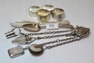 Group of four various silver napkin rings, antique silver spoon, silver butter knife and a