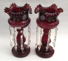 Pair of Victorian floral painted cranberry glass lustres with drops, 37cm high Some chipping and