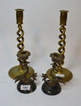 Pair of patinated brass candlesticks in the form of winged gryphons on marble plinths and a pair