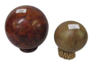 Large 20th Century burr wood turned sphere, together with another similar sphere