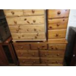 Large reproduction pine chest of drawers with knob handles, together with two similar smaller chests