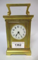 20th Century gilt brass cased carriage clock, the circular enamel dial with Arabic numerals (