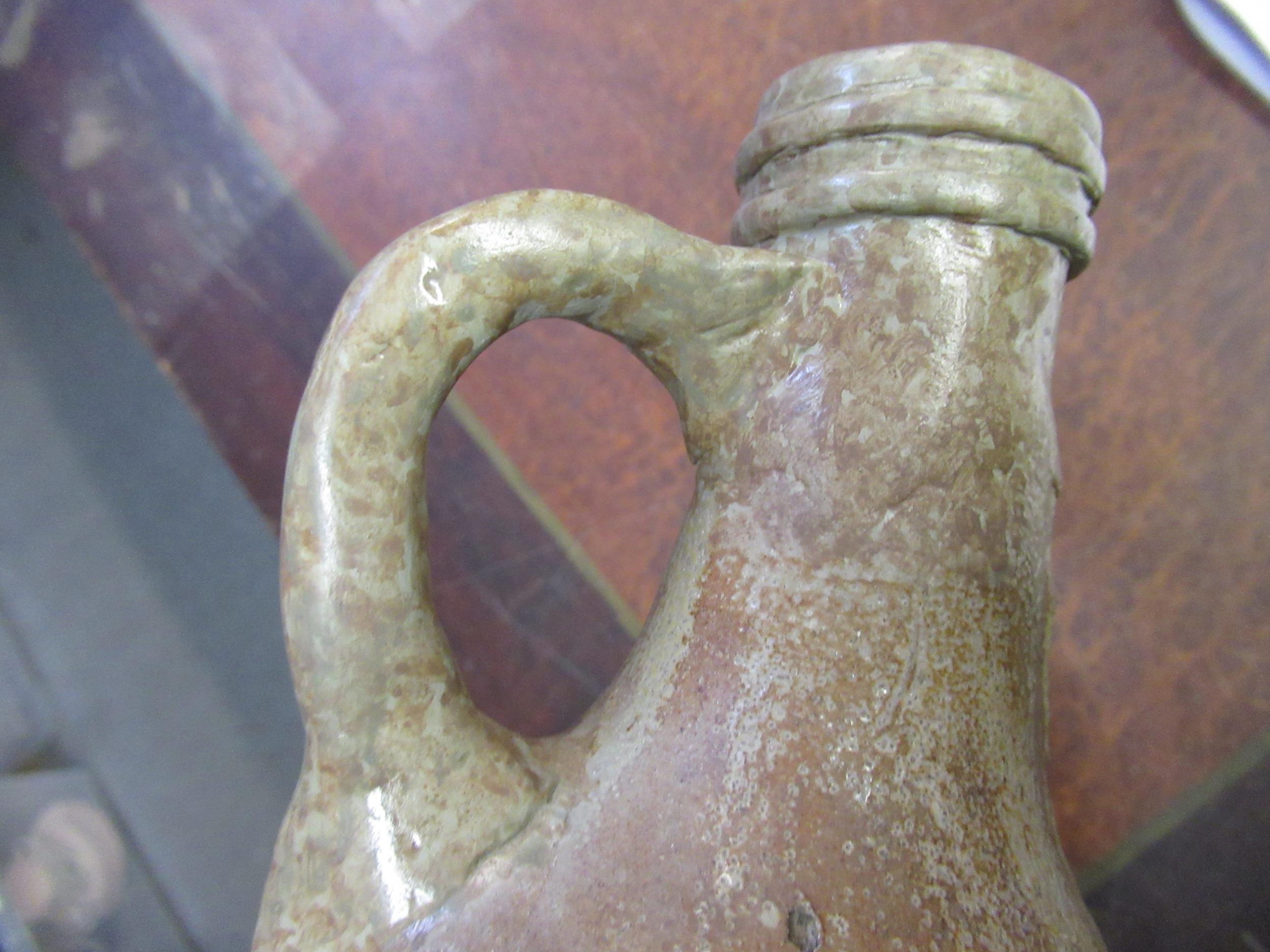 Two German stoneware mask head Bellarmine jugs, together with a terracotta bottle (all restored) - Image 7 of 9