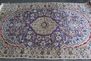 Indo Persian rug with a medallion and all-over palmette design on a mauve ground with borders, 216 x
