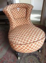 Victorian upholstered nursing chair on ebonised turned and fluted front supports