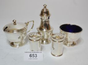 Birmingham silver three piece condiment set and two small silver peppers